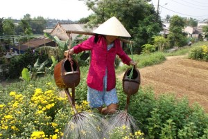 Woman watering the community garden in Hue